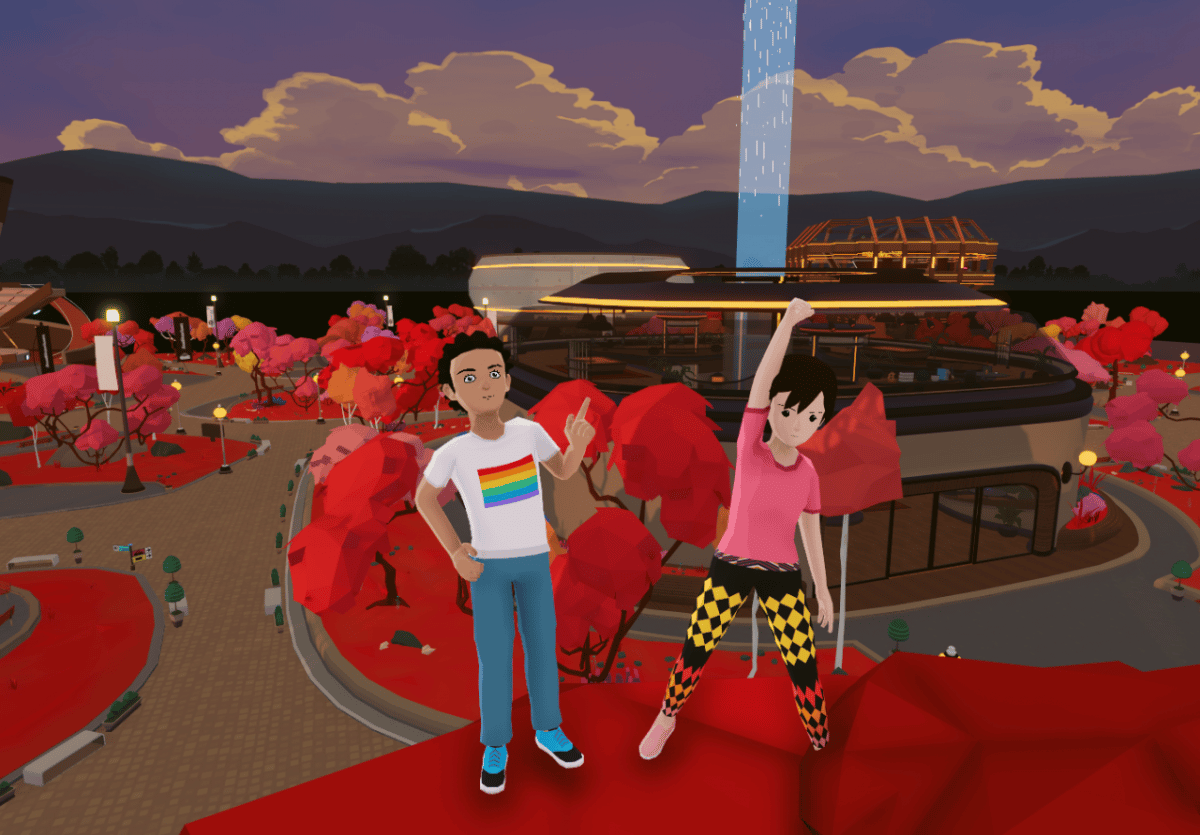 Two virtual avatars stand in front of a lit-up stadium in support of the Decentraland Ugly Sweater Competition.