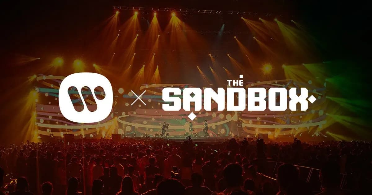 image of Sandbox's metaverse logo and Warner Music's logos side by side on top of a convert crowd